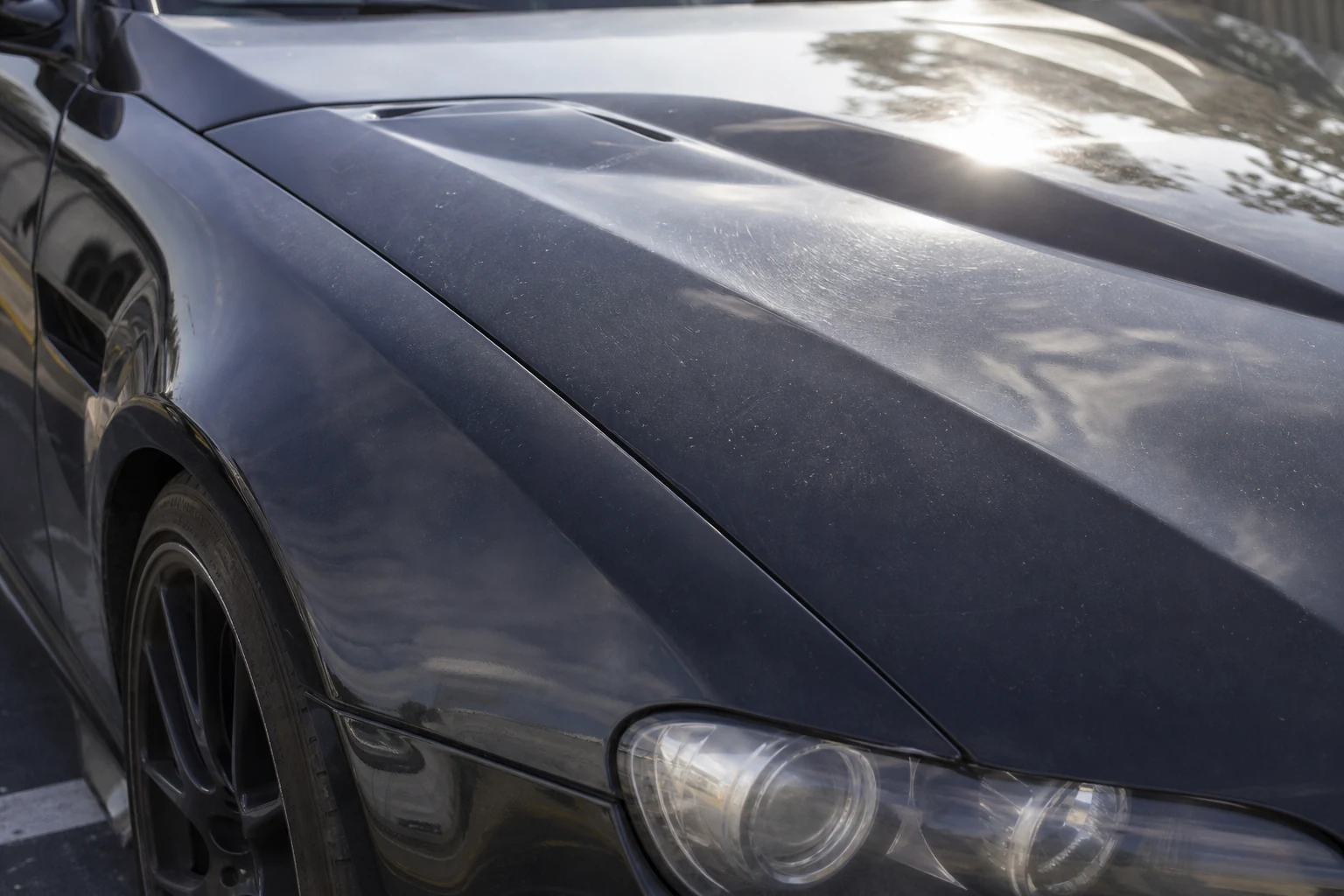 Luxury vehicle paint before correction with visible haze and reduced gloss